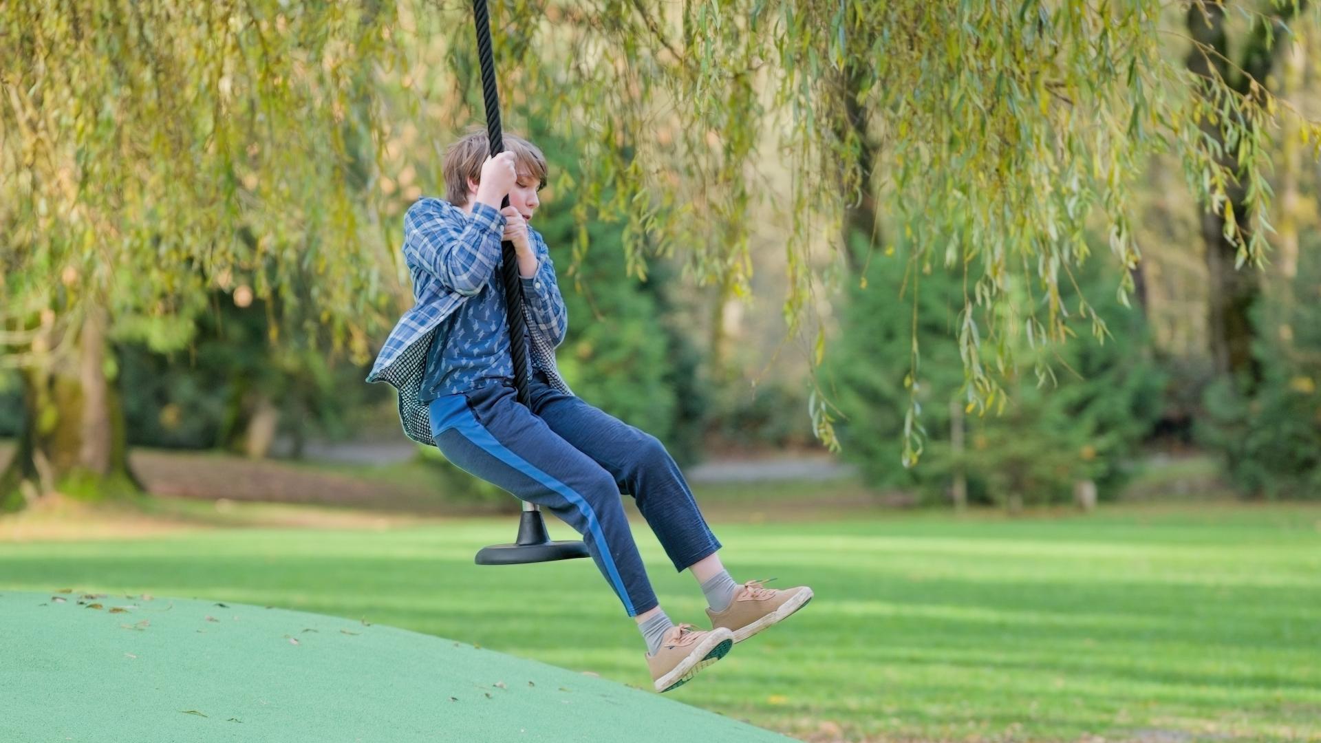 Boy playing on zipline